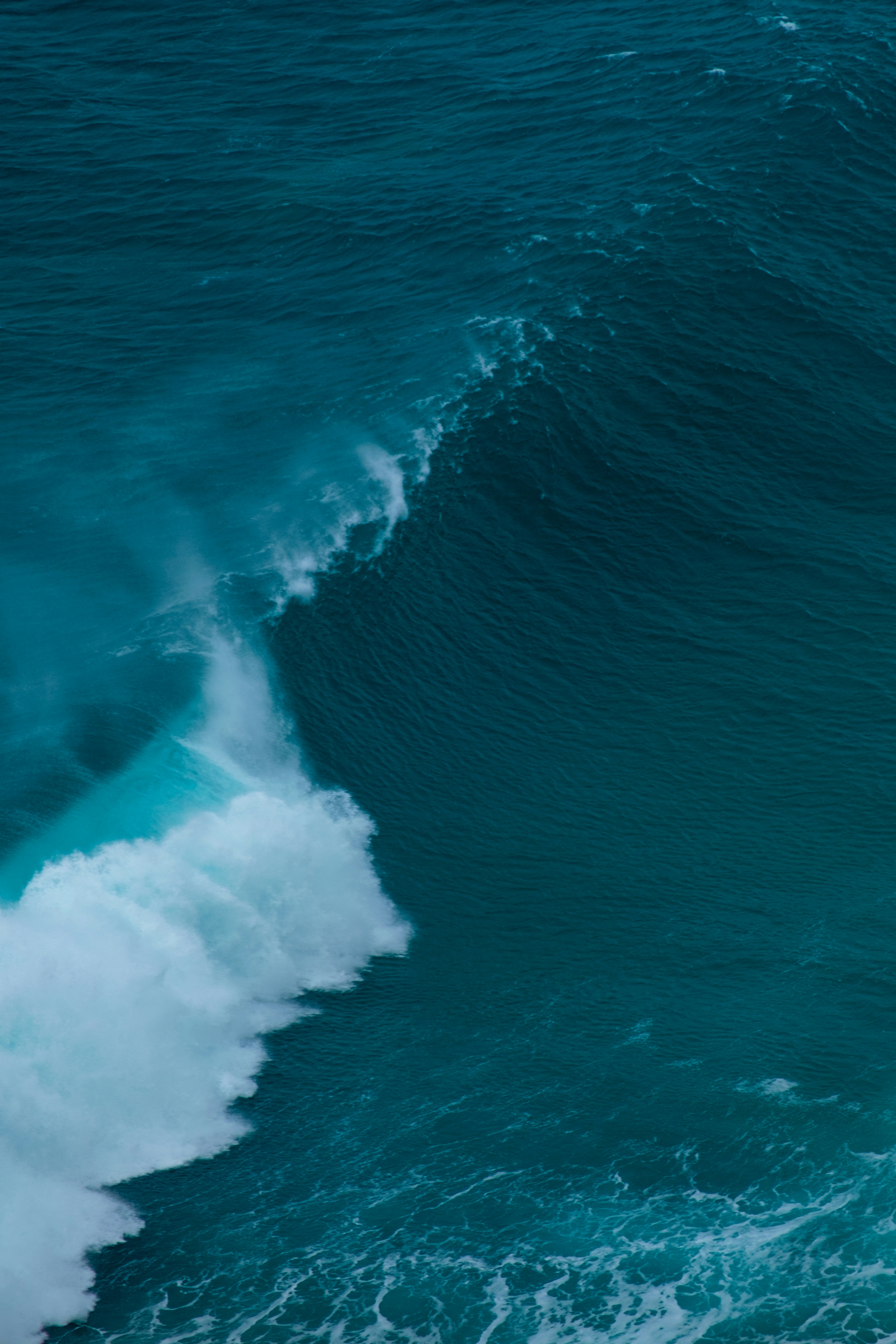 a man riding a wave on top of a surfboard