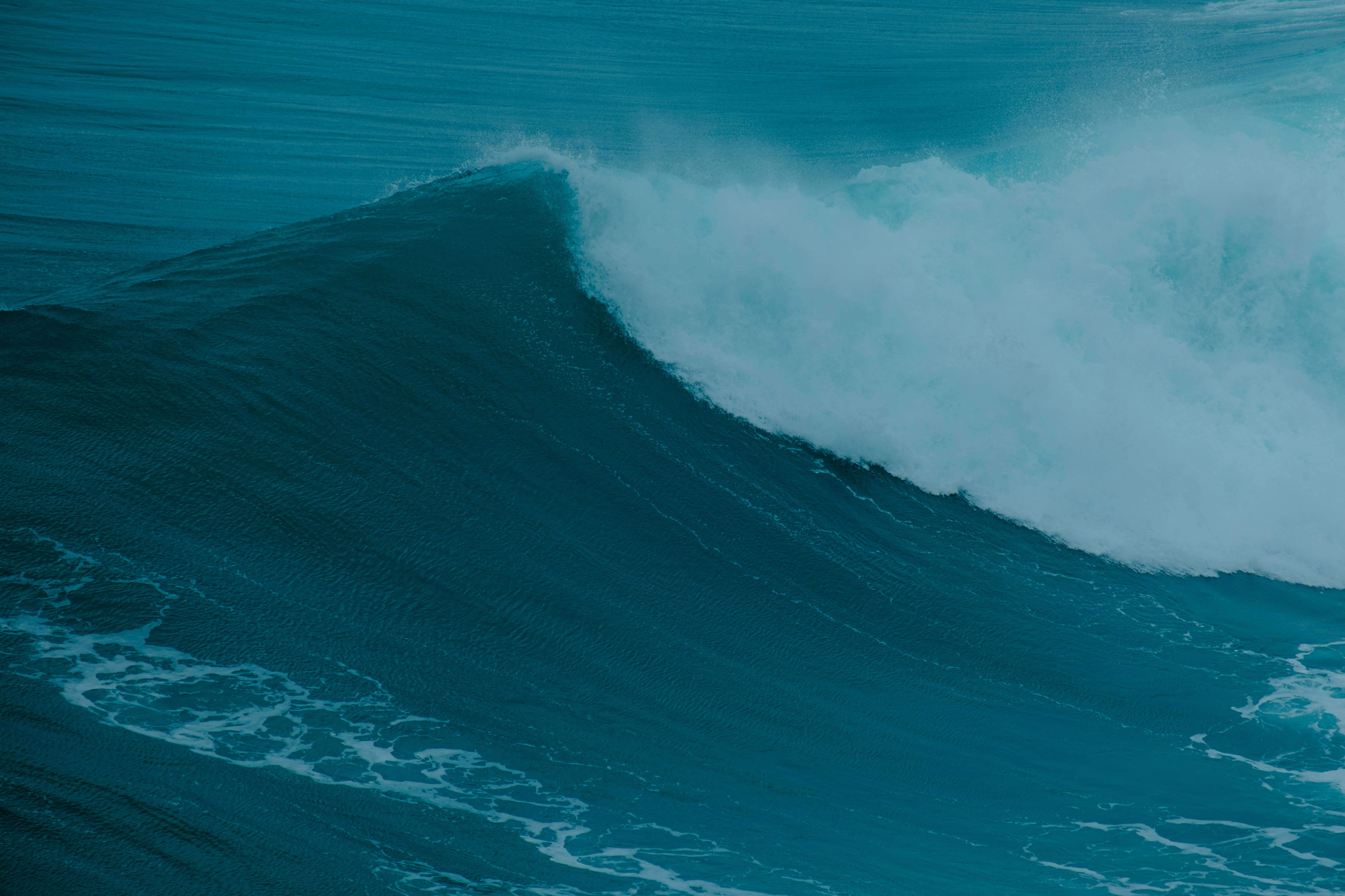 a man riding a wave on top of a surfboard