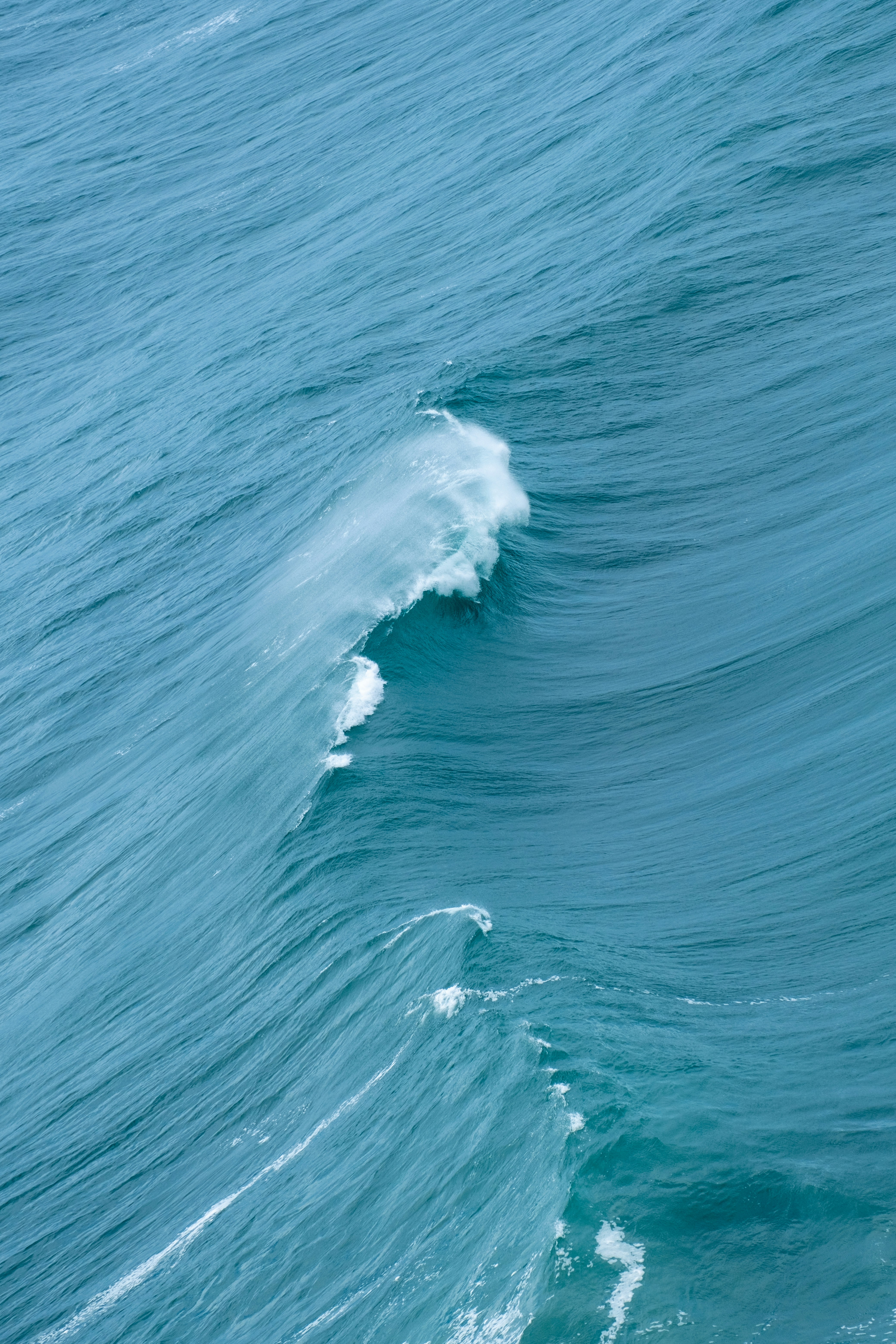 a person riding a surfboard on a wave in the ocean