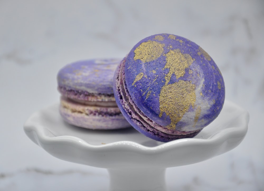 two macaroons are sitting on a white plate
