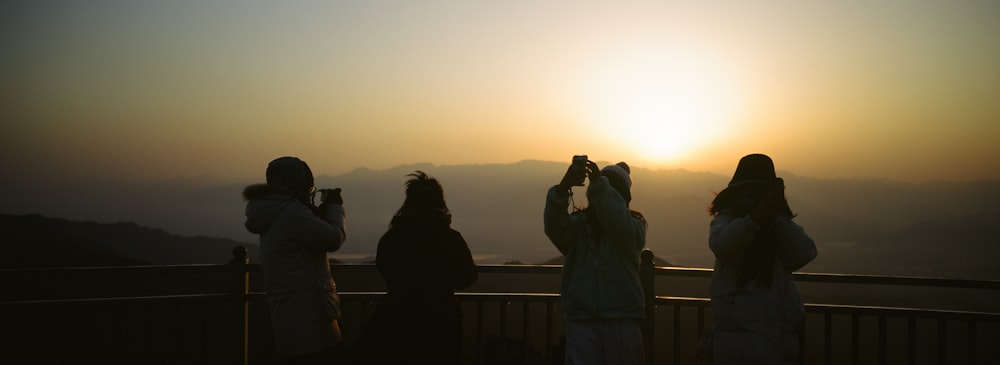 a group of people standing on top of a hill