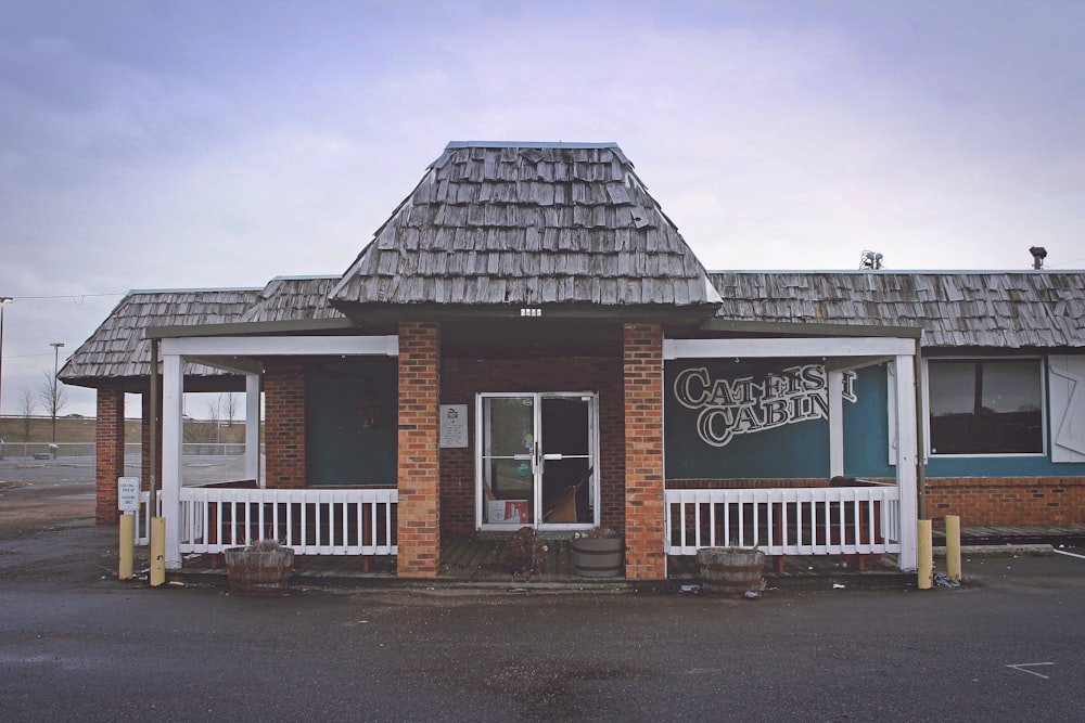 a small brick building with a white porch