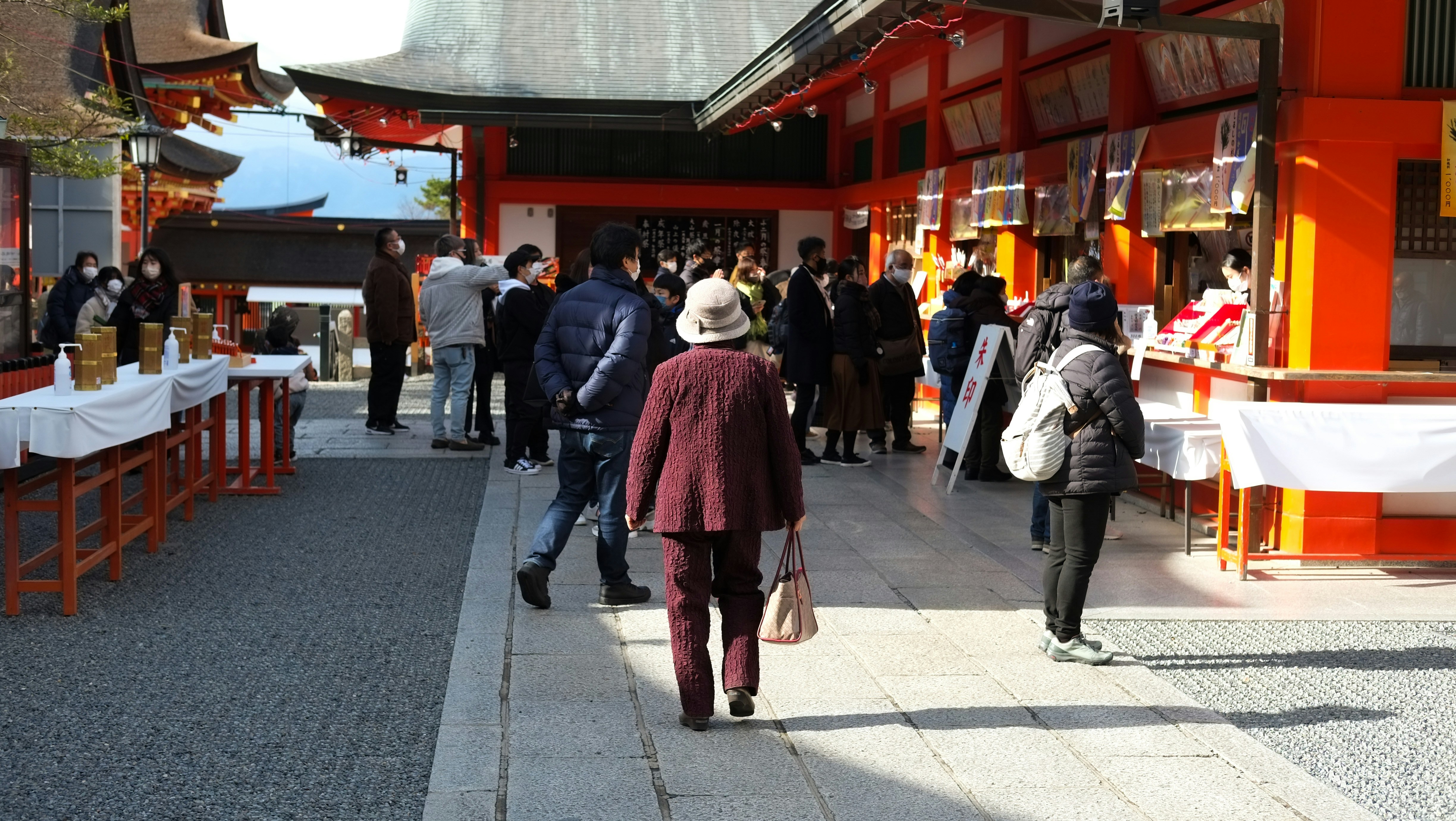 Long queue of people entering a large Japanese shrine for Hatsumode