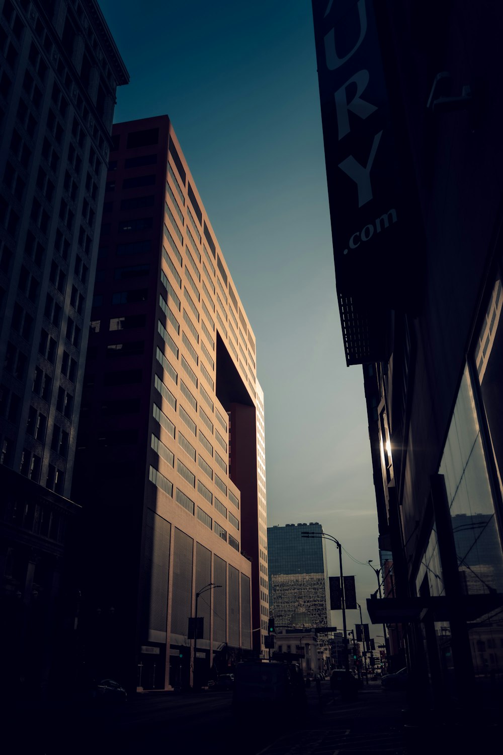 a city street with tall buildings and a traffic light