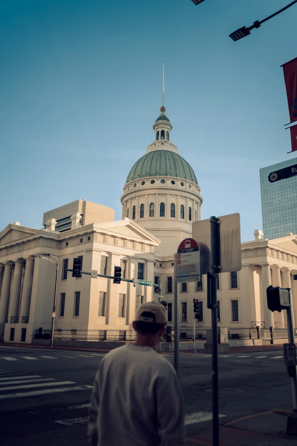 a man walking across a street in front of a building