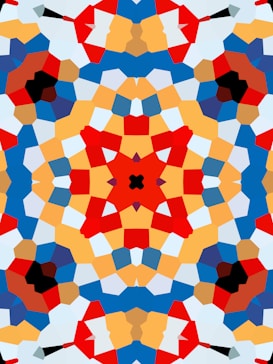 A vibrant, symmetrical kaleidoscope pattern featuring bold geometric shapes in various colors. The design is complex, with intersecting lines and layered segments creating a visually appealing mosaic-like effect.