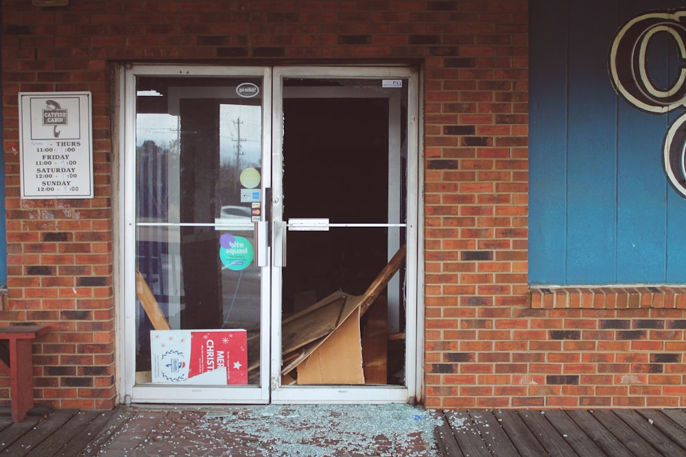 a store front with a broken glass door