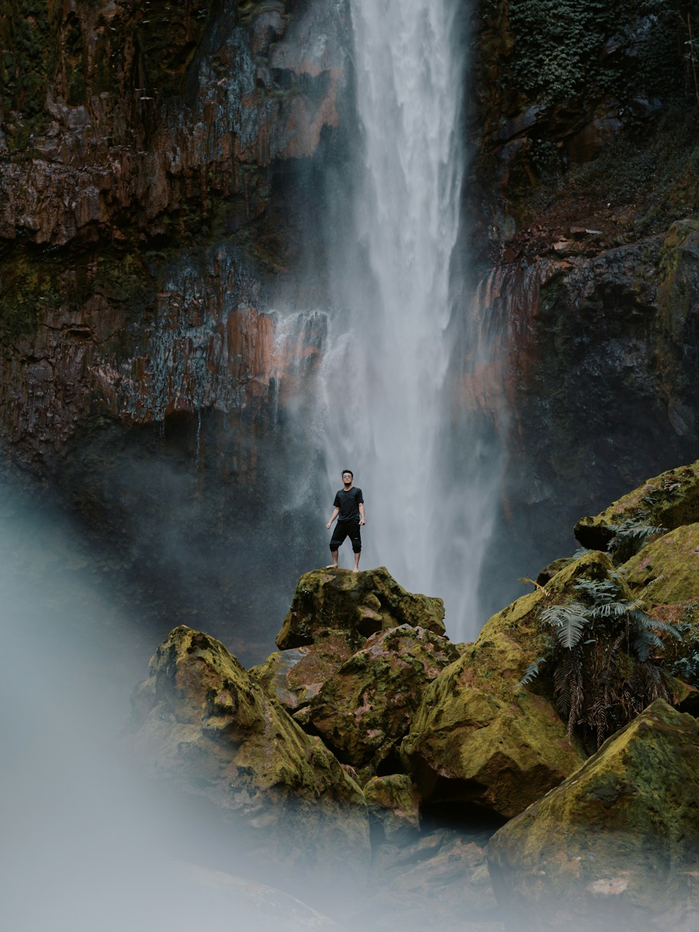 a person standing in front of a waterfall