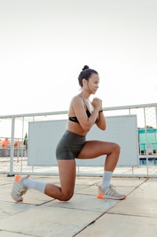a woman is squatting on a tile floor