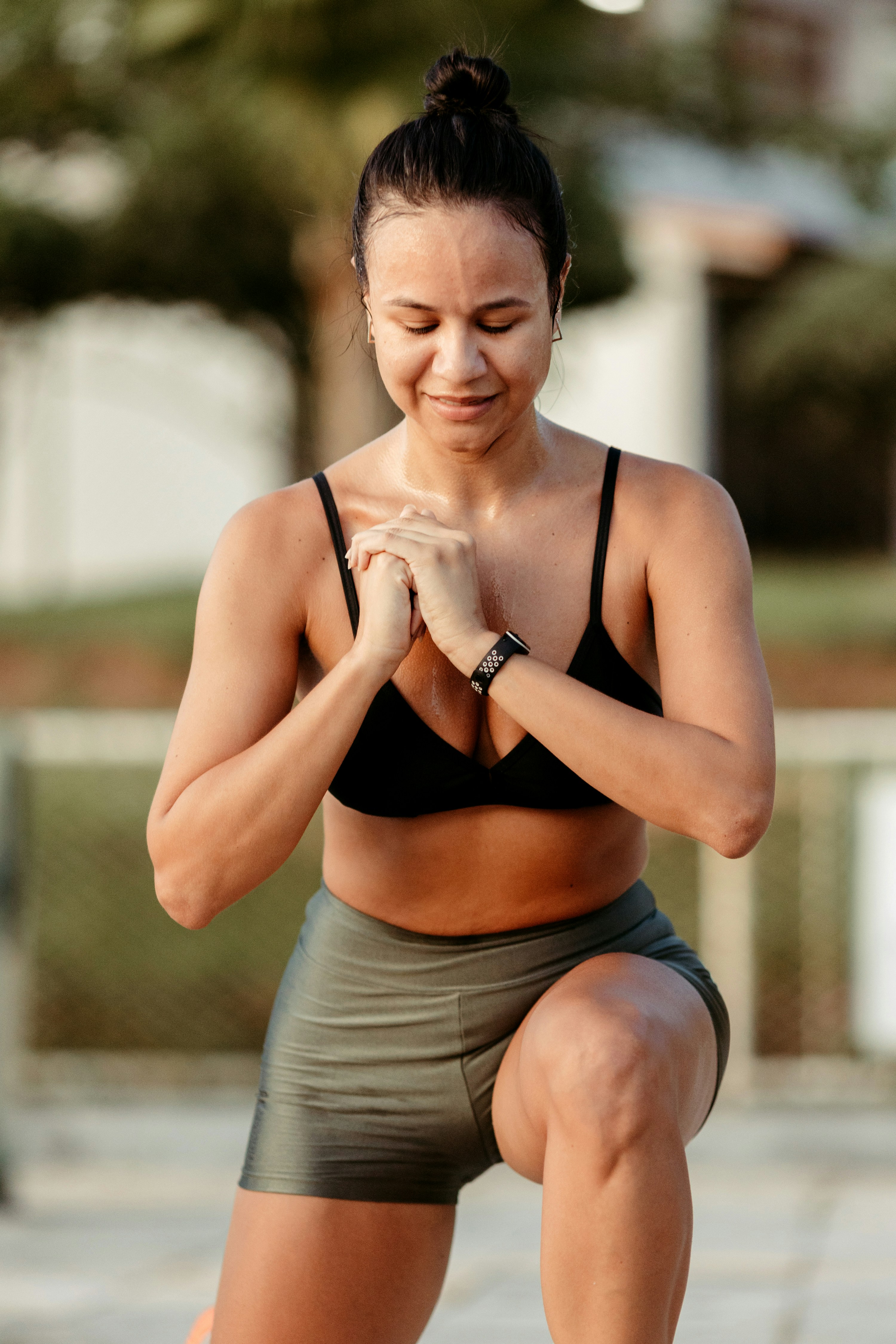 a woman kneeling down with her hands together