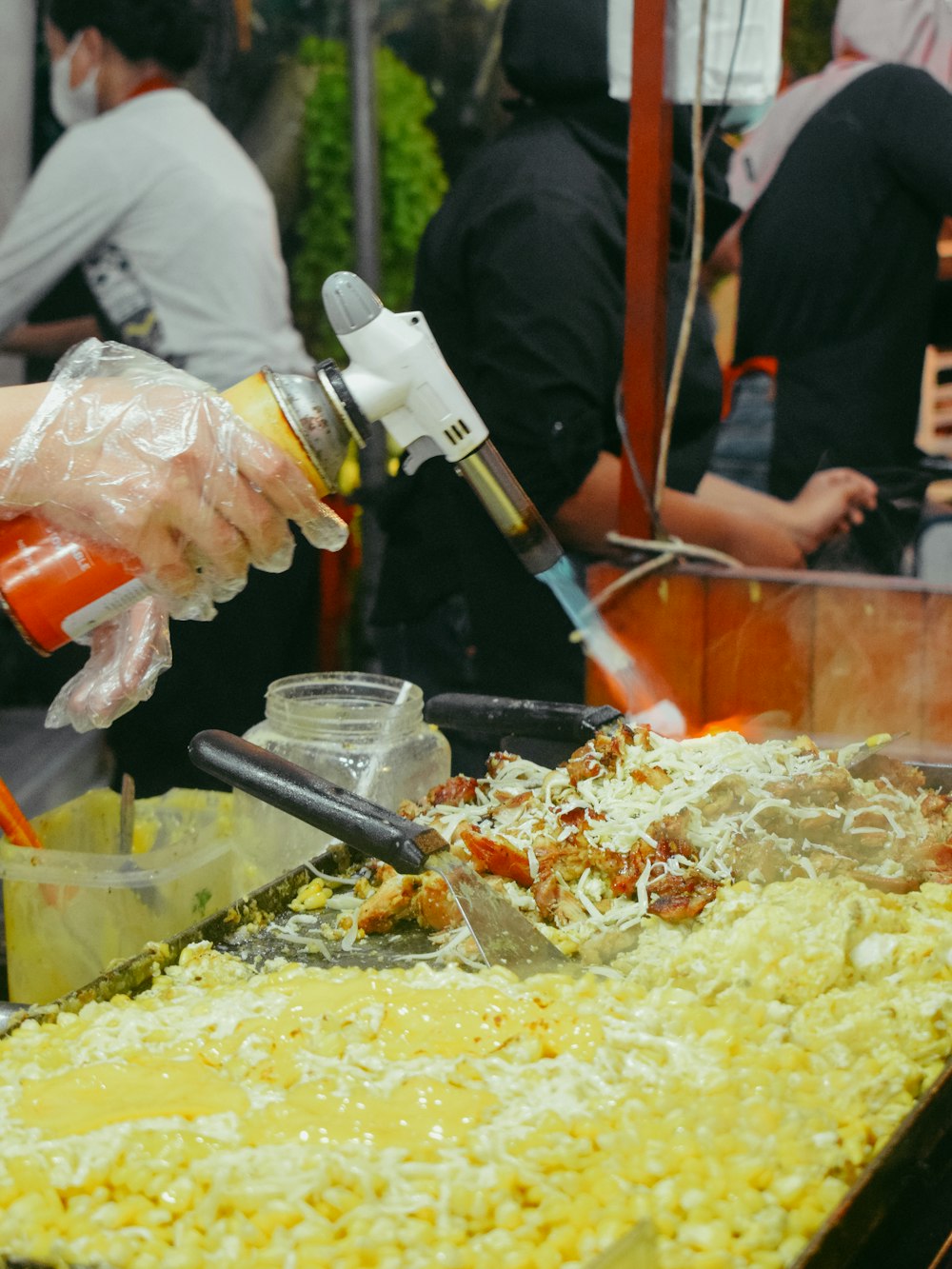 a person is pouring something into a bowl of food