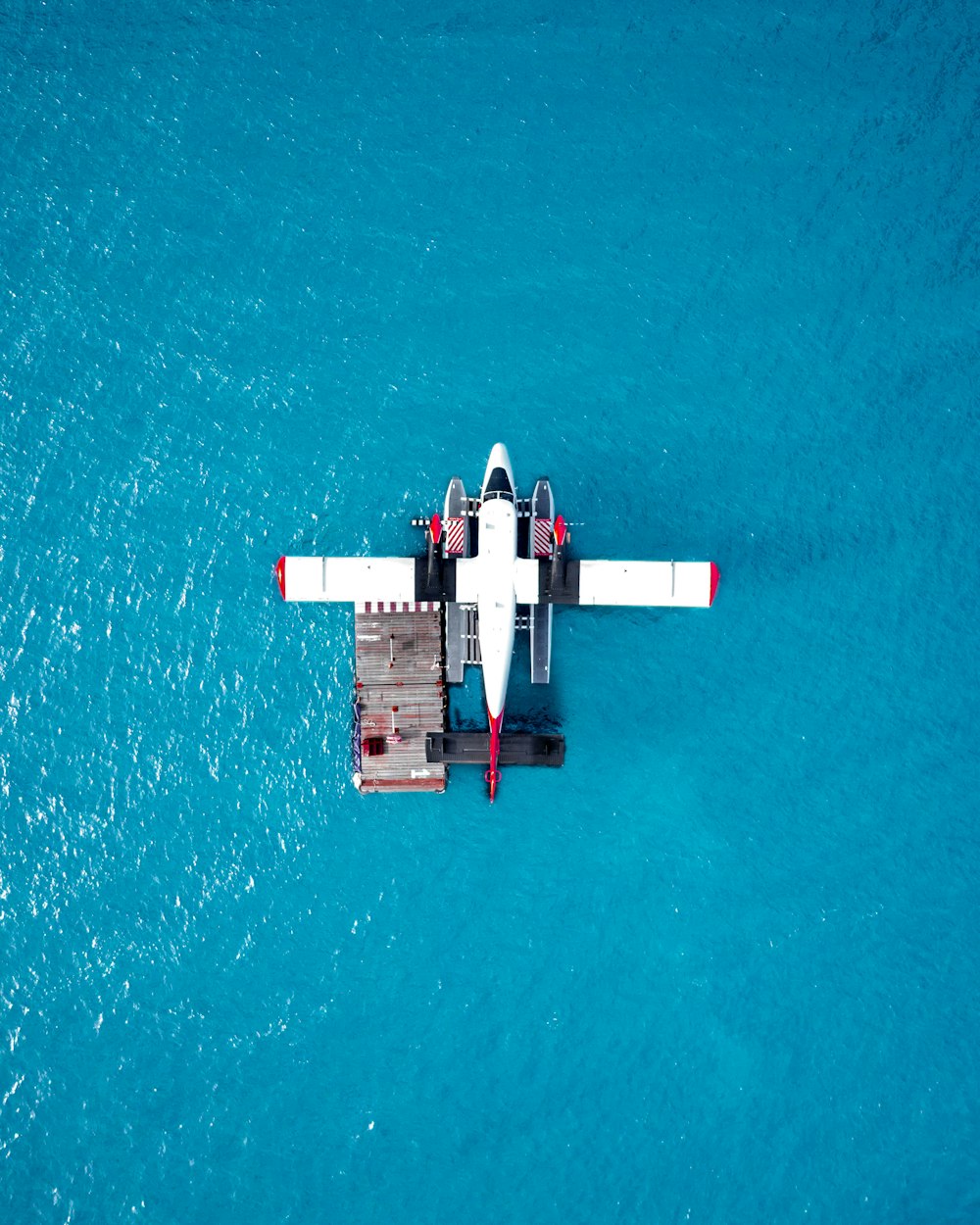 an aerial view of a small plane in the water