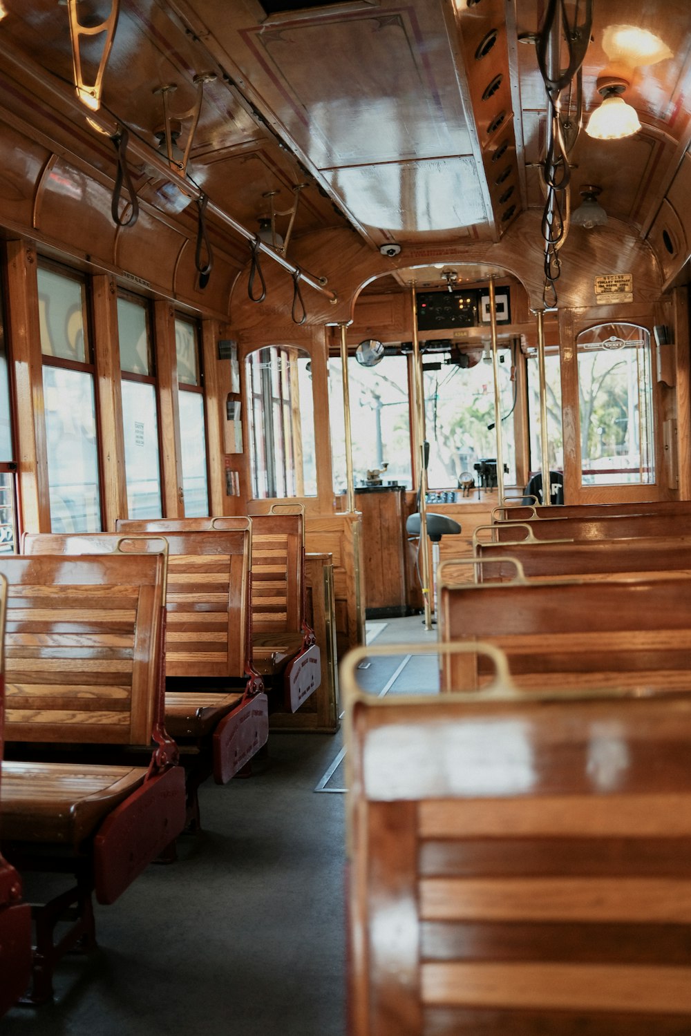 the inside of a train car with wooden seats