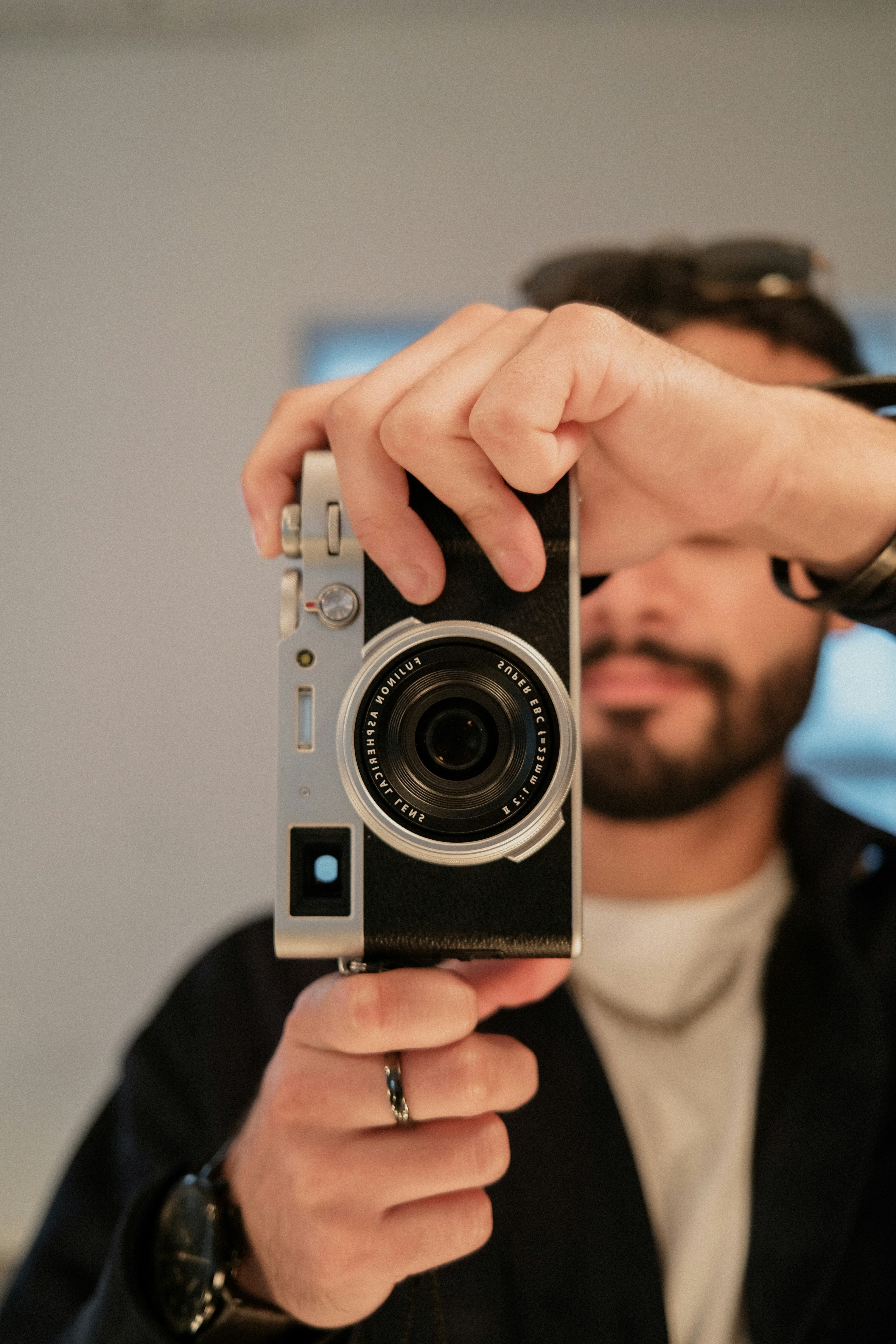 a man holding a camera up to take a picture