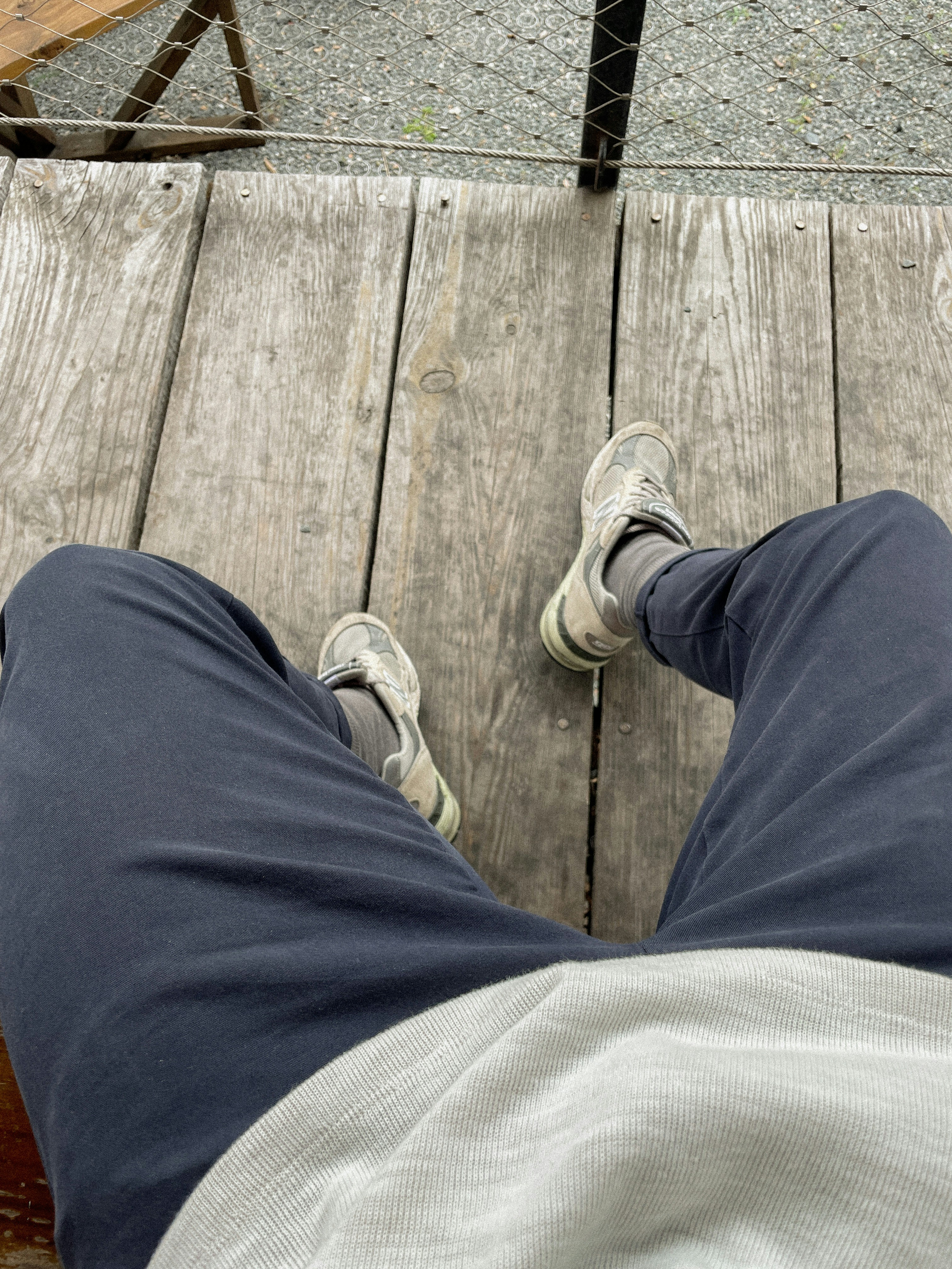 a person standing on a wooden platform with their feet up