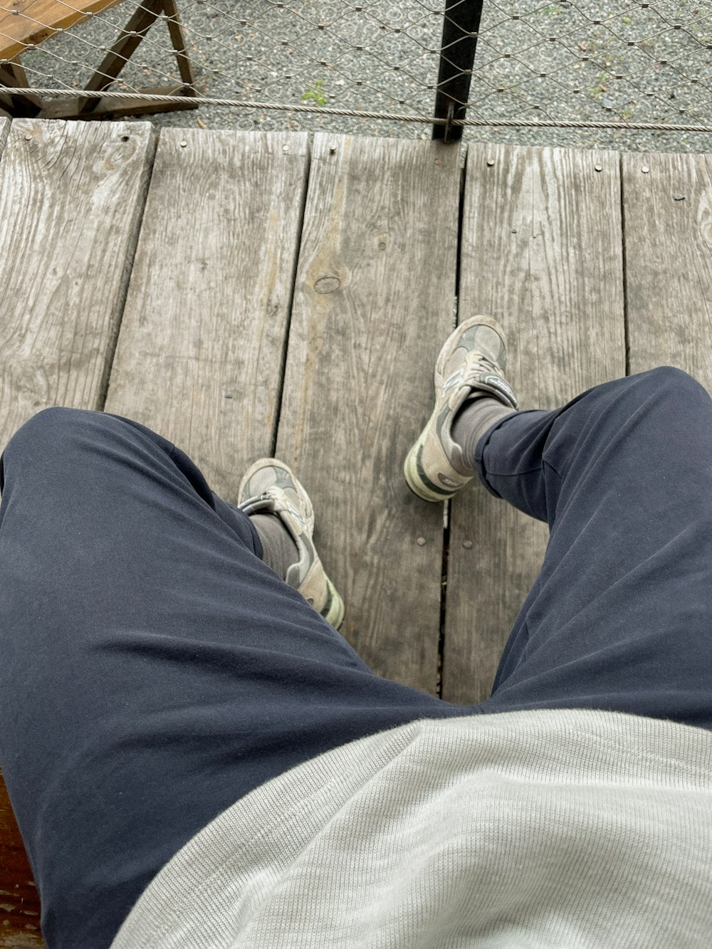 a person standing on a wooden platform with their feet up