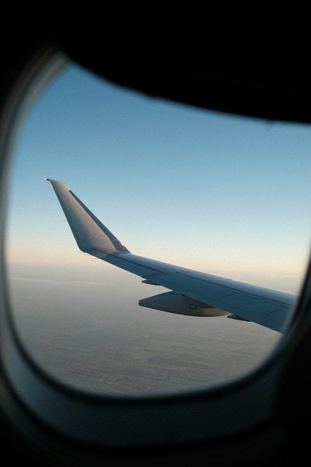 a view of the wing of an airplane in the sky