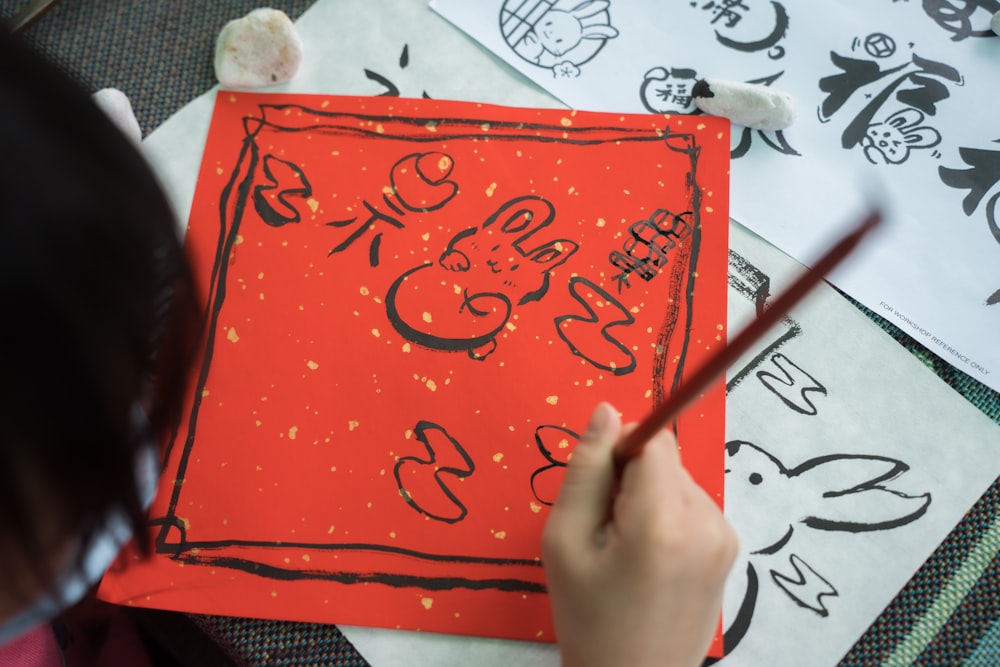 a child is drawing on a piece of paper