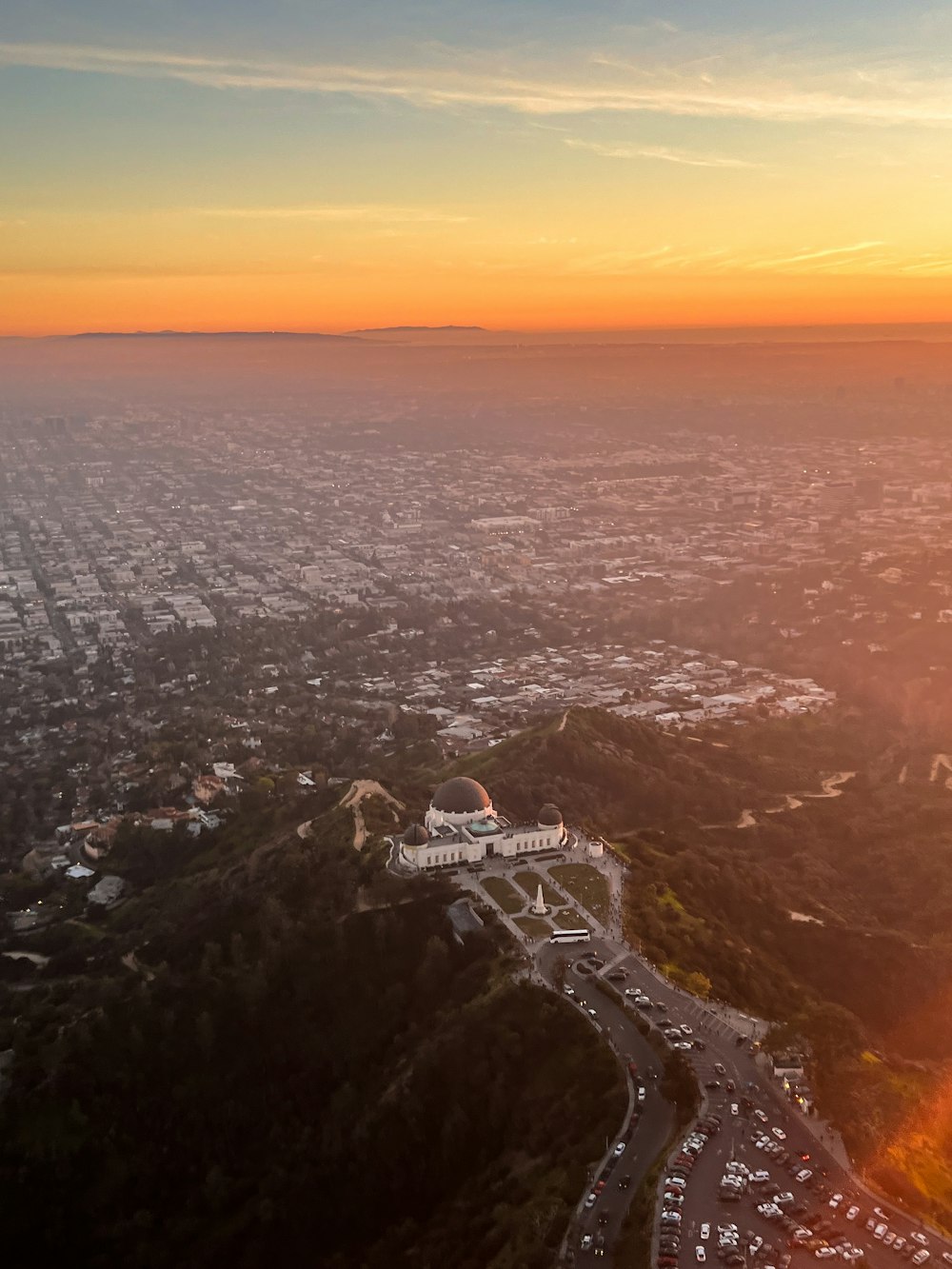 an aerial view of a city at sunset