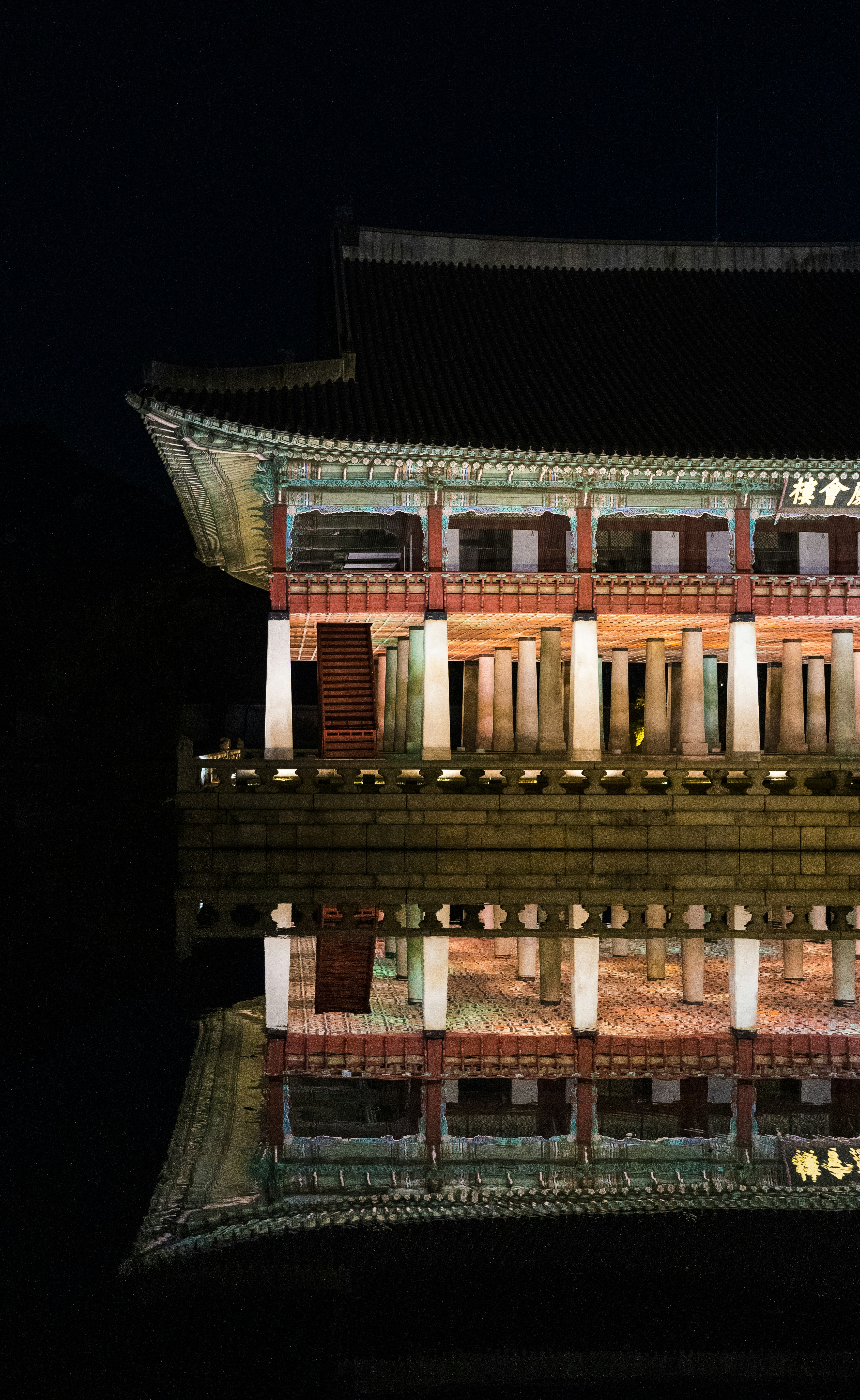 a reflection of a building in a body of water