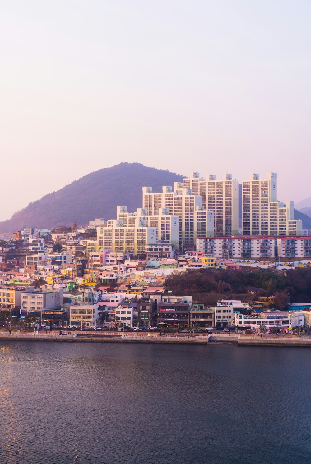 a large body of water with a city in the background