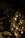 A small, decorative Christmas tree adorned with lights and golden ornaments is placed against a dark background. The tree is illuminated, creating a warm, festive glow. A guitar neck is partially visible behind the tree, lying on a patterned fabric with floral motifs.