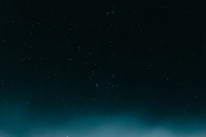 A starry night sky with blue and black hues highlighting a digital download icon.