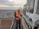 Professional consultant reviewing safety checklist in an industrial setting.