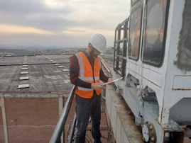 Professional consultant reviewing safety checklist in an industrial setting.