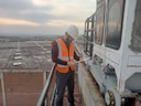 Professional consultant reviewing safety checklist in an industrial setting.