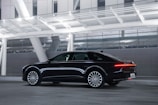A luxury sedan gleaming under city lights, ideal for corporate clients.
