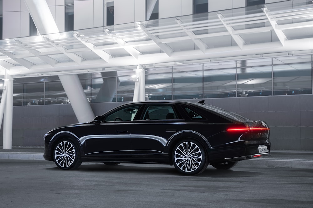 a black car parked in front of a building