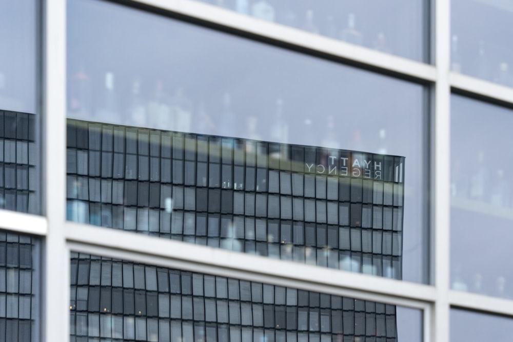 the reflection of a building in the windows of another building