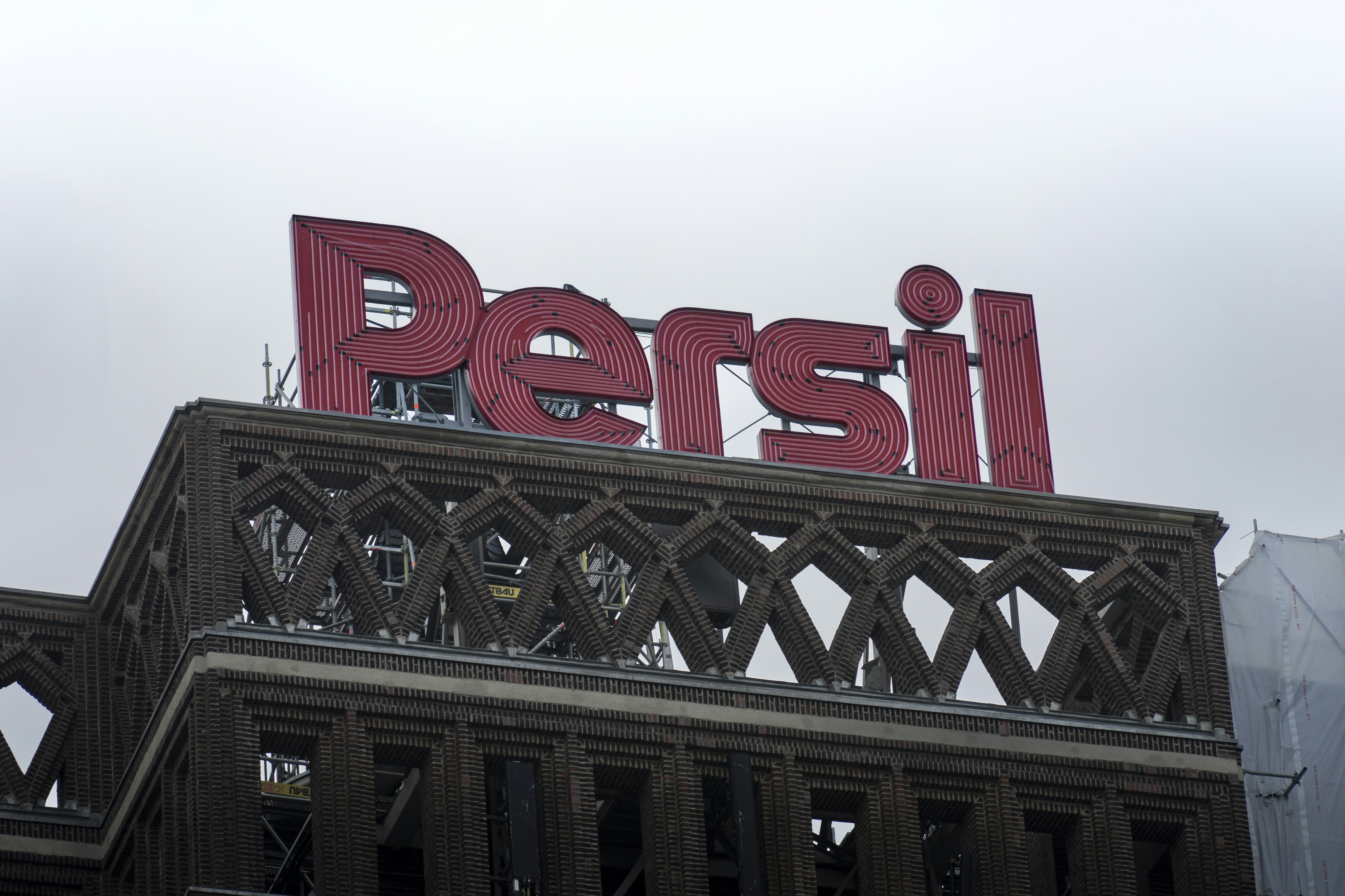 a large red sign on top of a building, 