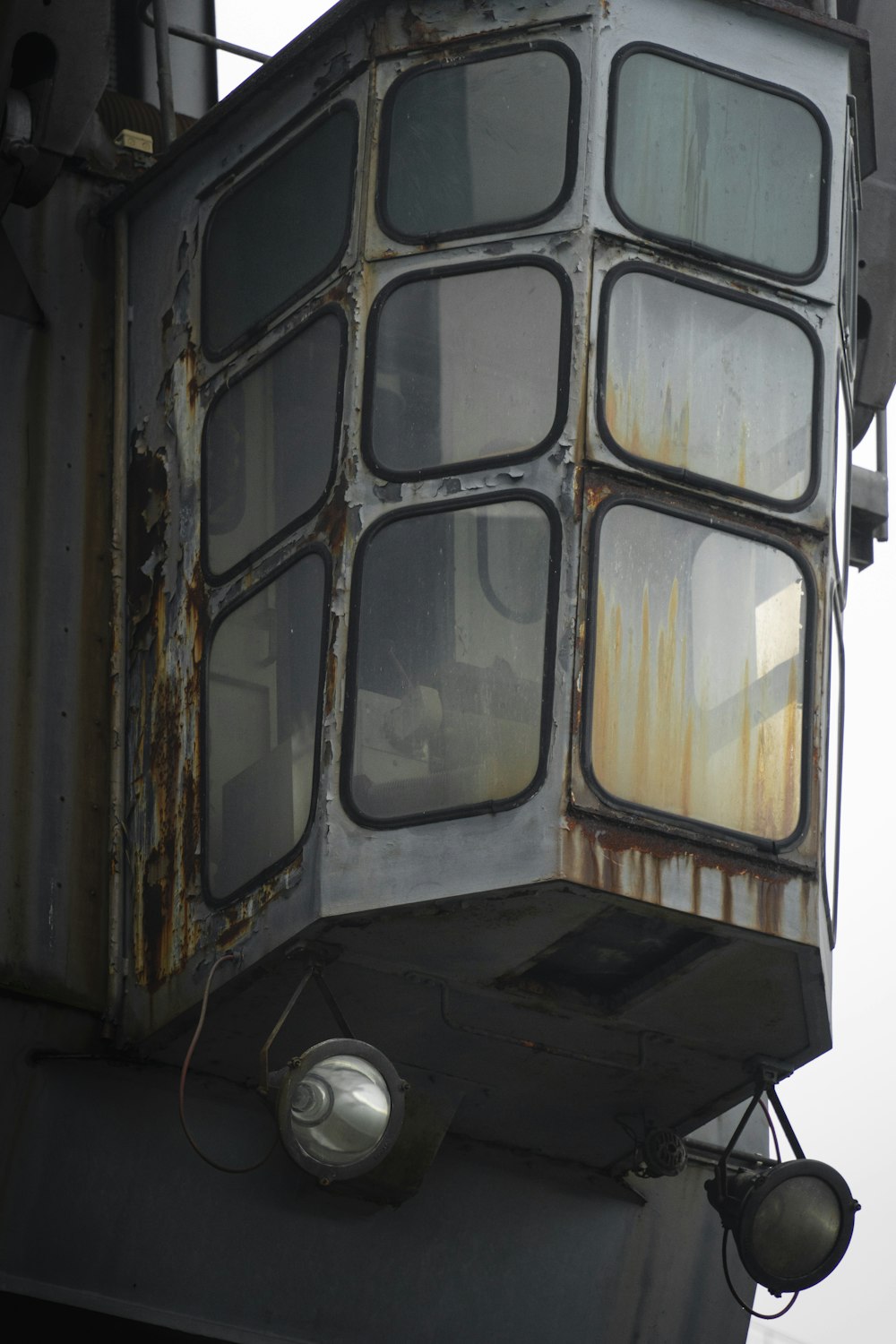 a rusted metal structure with a light on top of it