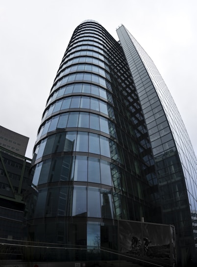 Modern commercial building in London featuring elegant glass facades and reflective curtain walls.