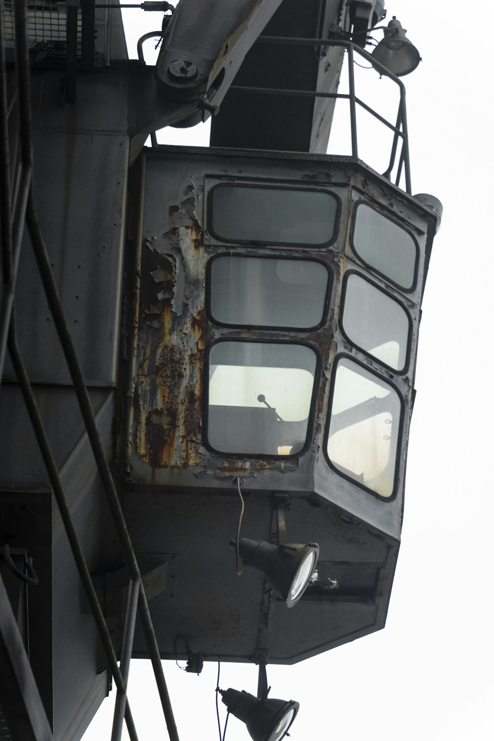 a rusted metal object hanging off the side of a building