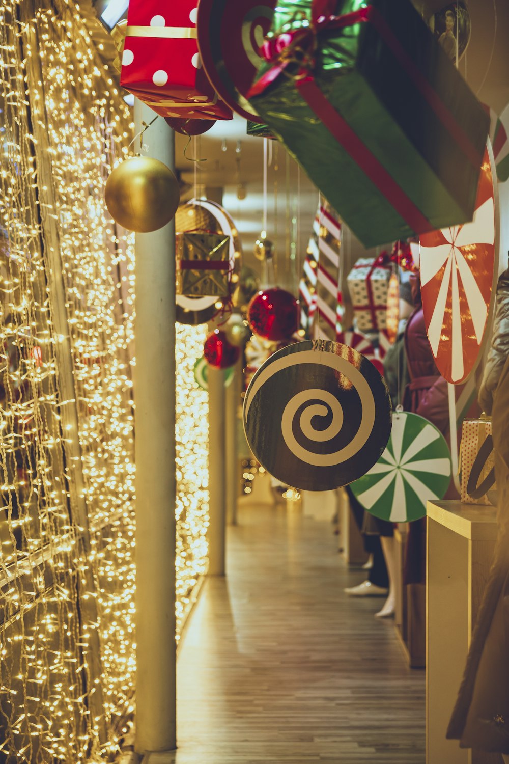 a hallway with christmas decorations and lights on the walls