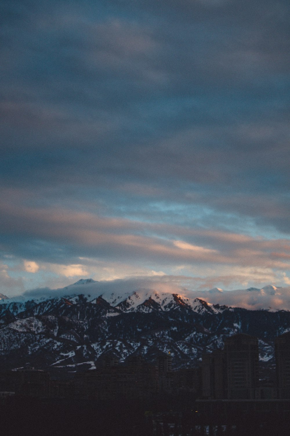 a view of a city with mountains in the background