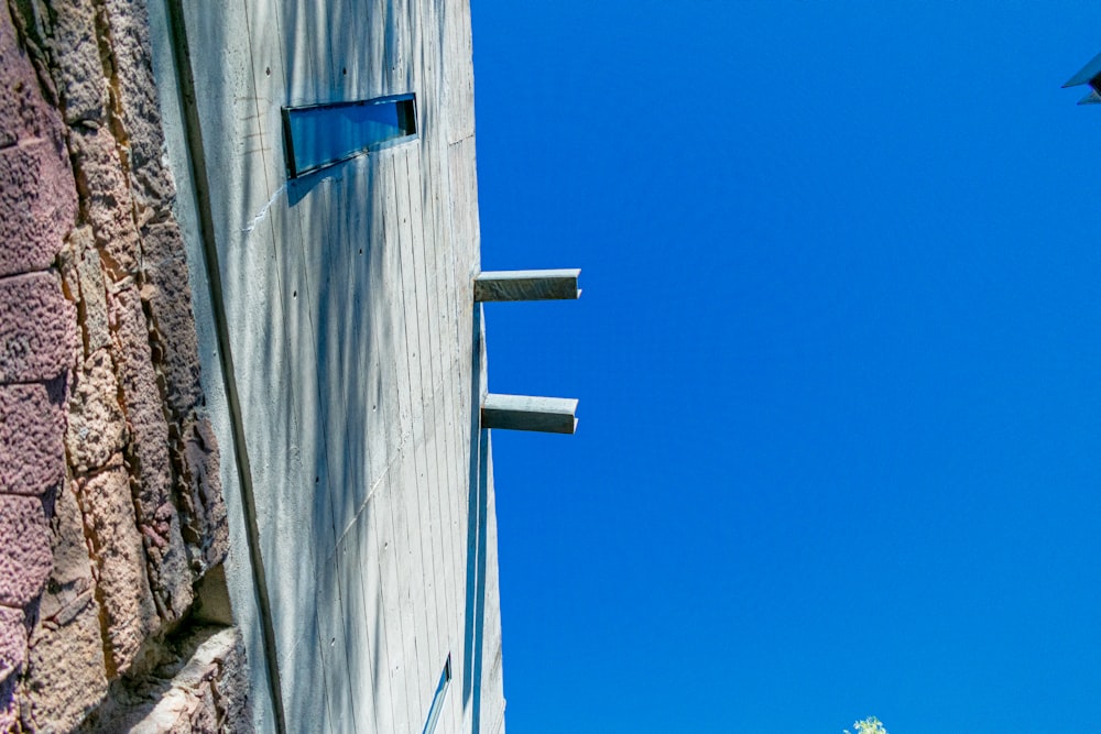 a bird flying in the air next to a building