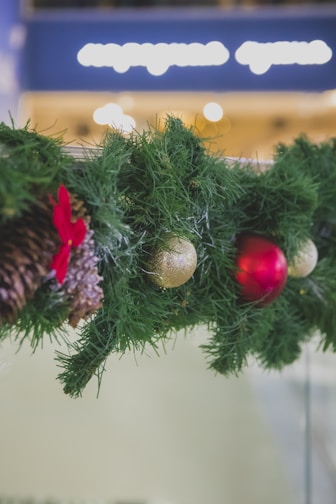 A festive Christmas cedar garland draped over a cozy porch railing with soft lights.