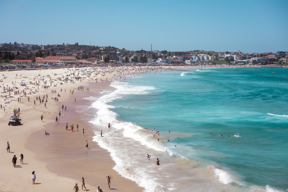 a crowded beach with many people on it