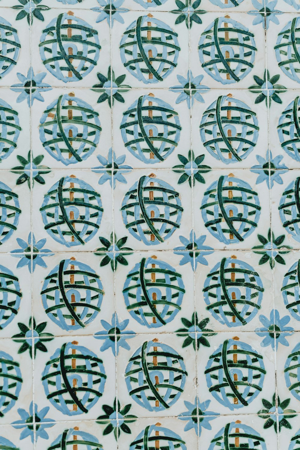 a close up of a tile with designs on it