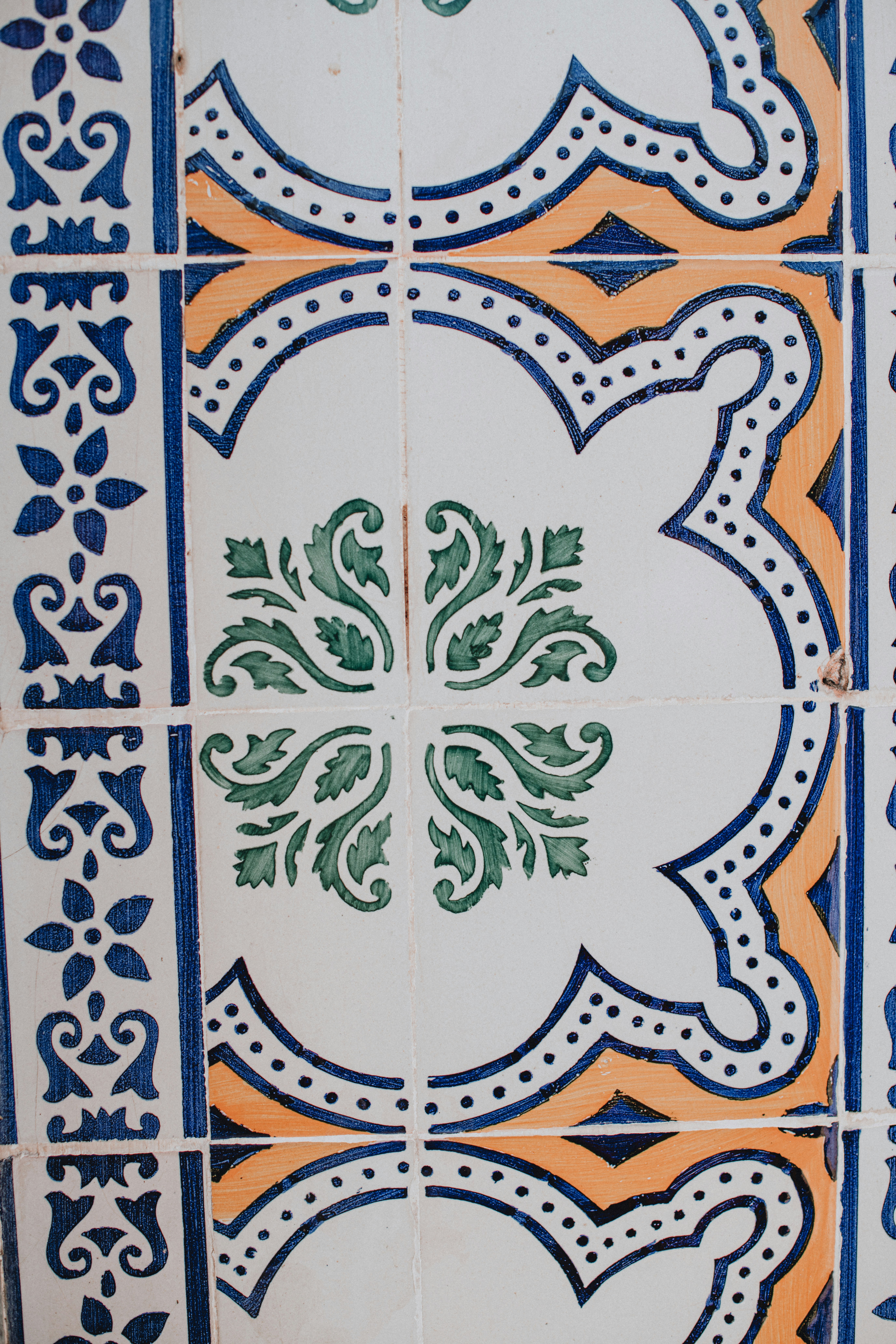 a close up of a tile with a flower design on it