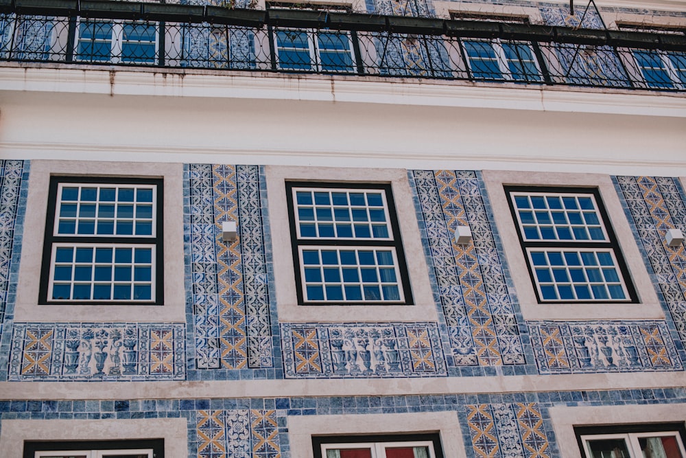 a building with blue and yellow tiles on it