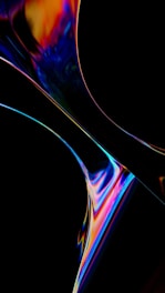 An abstract digital artwork featuring swirling, colorful patterns against a dark background. The composition includes vibrant hues of blue, orange, pink, and yellow with smooth, flowing curves that suggest fluid motion.