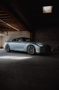 A beautifully restored Silverstone sports car parked in a sunlit garage.