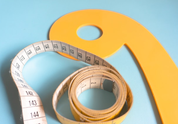 a measuring tape and a tape measure on a blue background