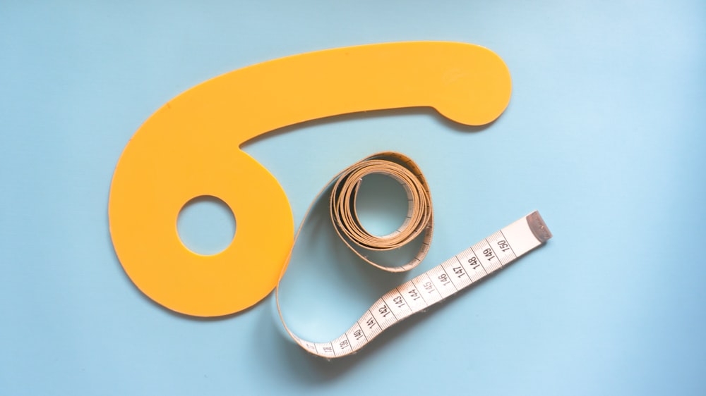 a measuring tape and tape measure on a blue surface