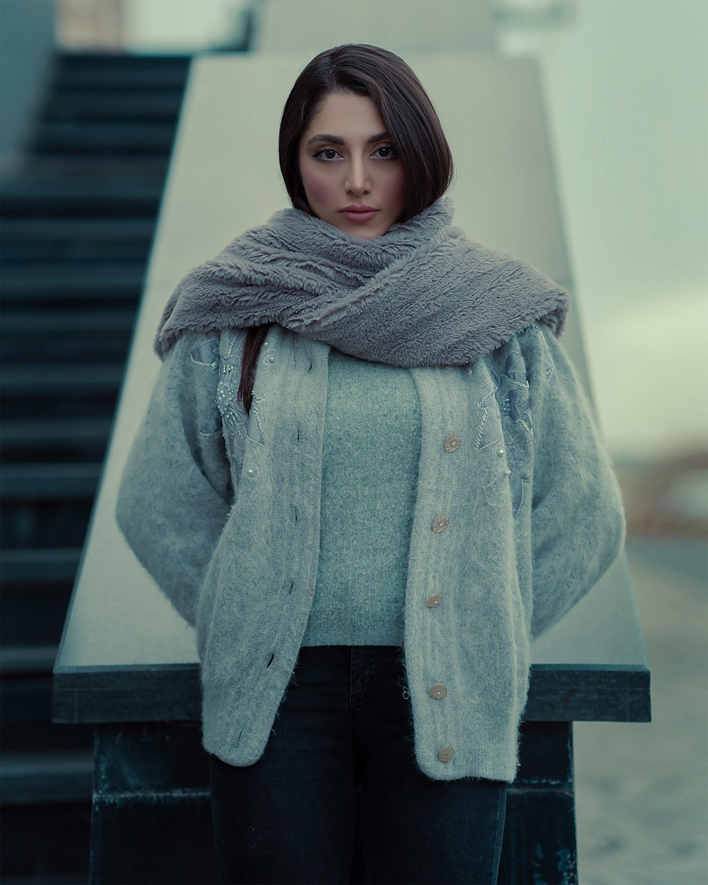 a woman standing in front of a stair case